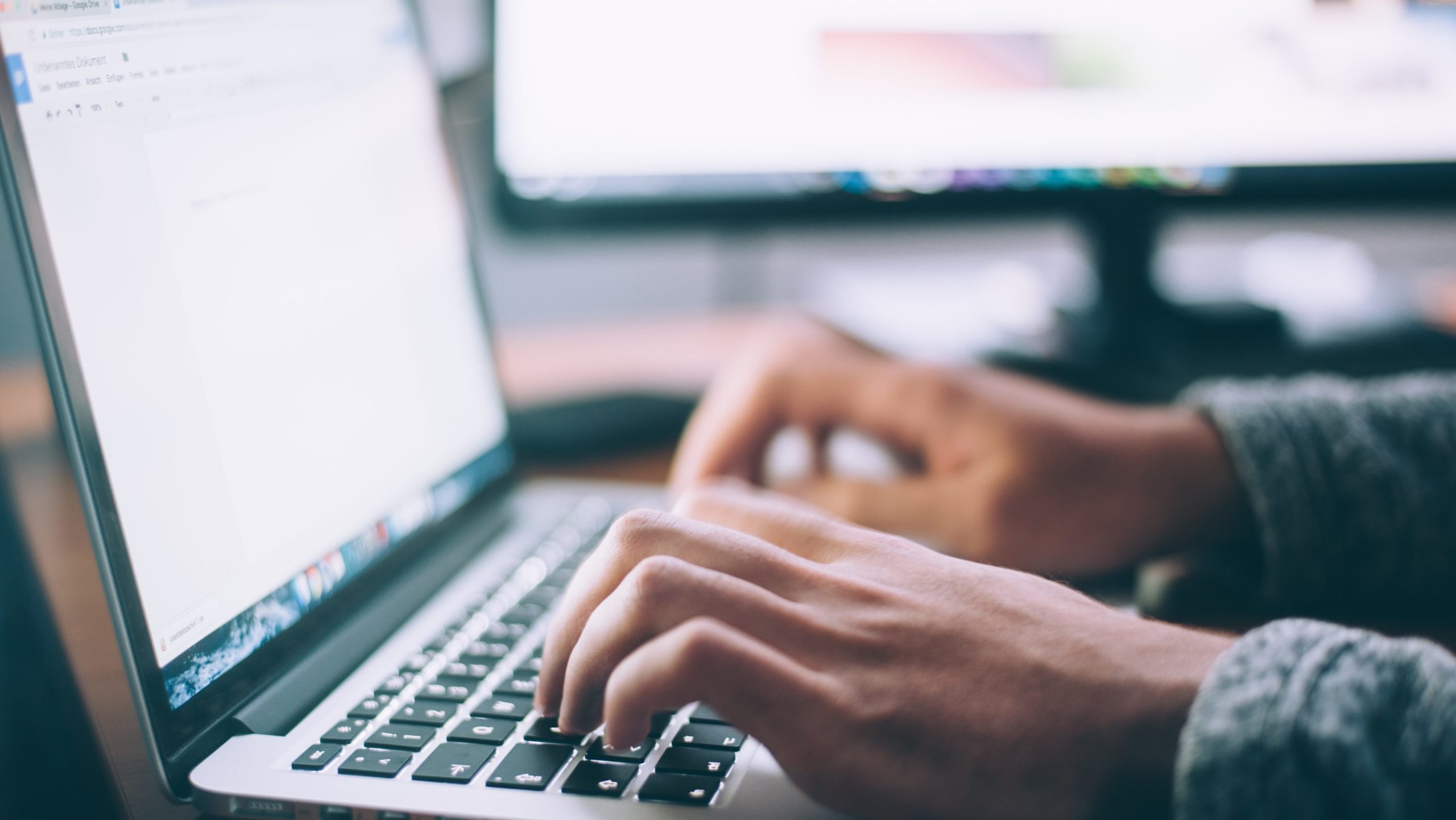 Person typing on keyboard